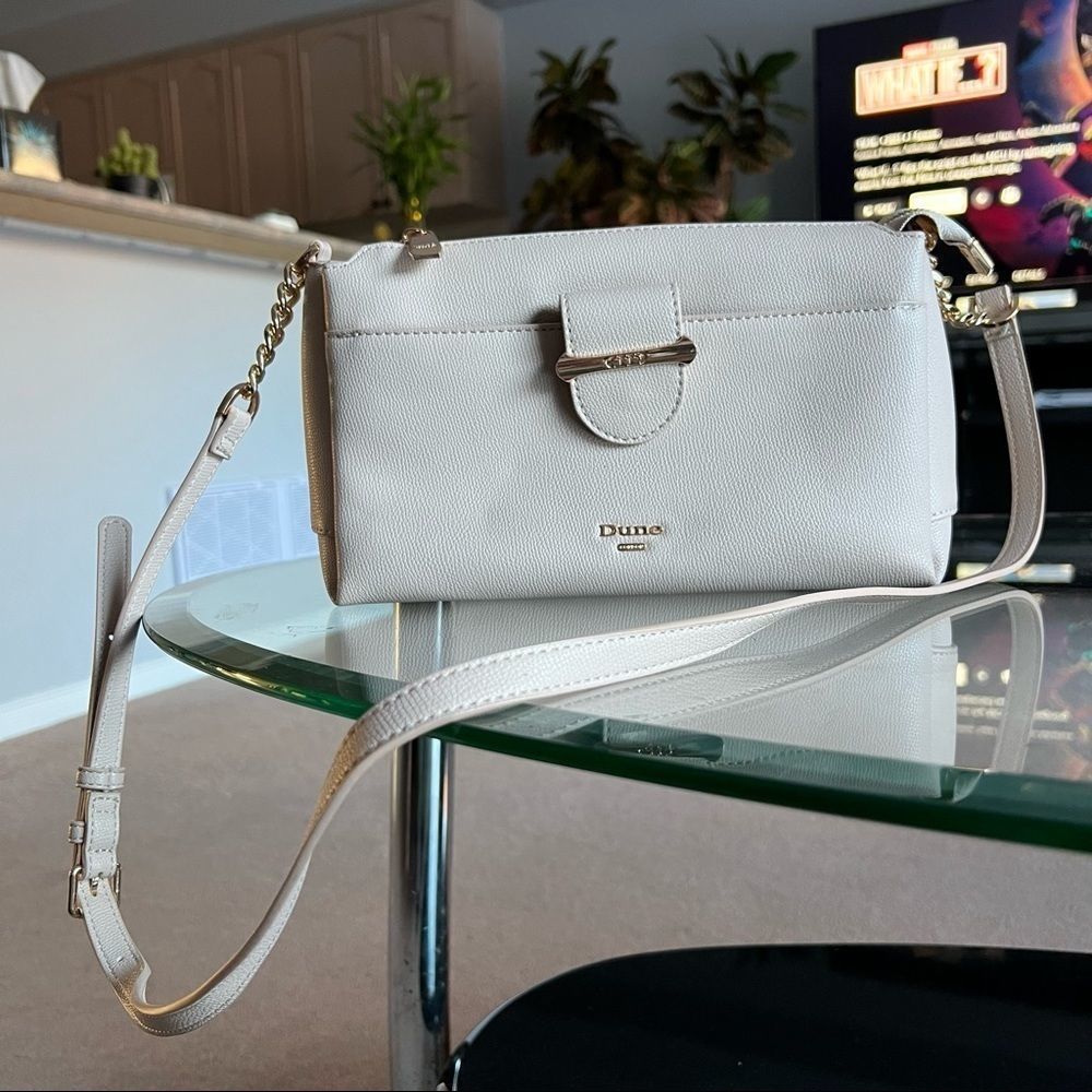Crossbody purse color cream with multiple pockets on inside from Dune